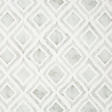 Kitchen mat surface with white and light gray repeating geometric tile pattern