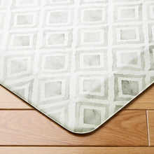 Light gray kitchen mat with repeating geometric squares pattern and rounded corners