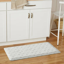 Kitchen mat with light gray geometric lattice design placed on hardwood flooring