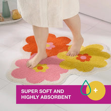 Bath mat with colorful flower pattern under a standing barefoot child