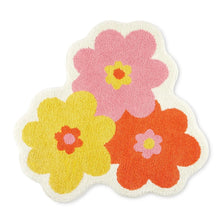 Floral shaped bath mat with pink, orange, and yellow flowers in a clover layout
