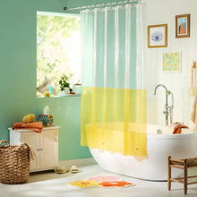Bath mat with bright floral design on bathroom floor in front of bathtub