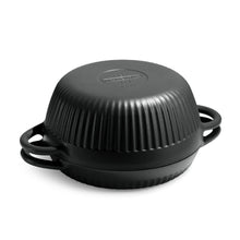 Black enameled cast iron Dutch oven with ribbed lid and side handles.