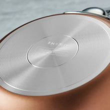 Nonstick cookware lid with embossed markings and brushed metal finish