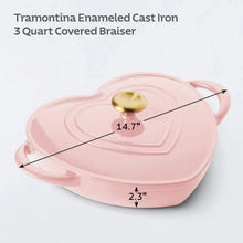 Heart-shaped enameled cast iron dutch oven in pink with gold lid knob, size shown