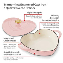 Heart-shaped pink enameled dutch oven with cream interior and gold knob lid