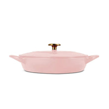 Heart-shaped enameled dutch oven in pink with gold knob and side handles
