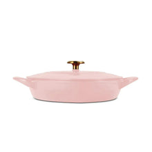 Pink heart-shaped enameled cast iron dutch oven with lid, gold knob, and side handles
