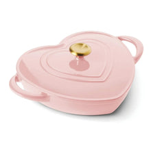 Heart-shaped enameled cast iron dutch oven with pink lid and gold knob