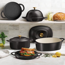 Black cast iron cookware set with matching lids and handles