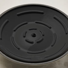 Black enamel cast iron lid with steam vents and gold knob