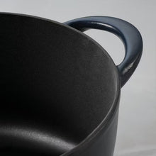 Black enamel cast iron pot rim and handle, close-up