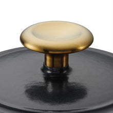 Black pot lid with gold knob and enamel finish on cast iron cookware