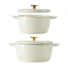 Pair of white enameled round Dutch ovens with gold knobs