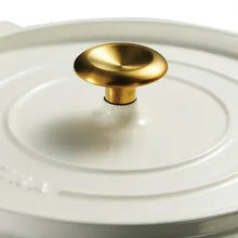 White enameled Dutch oven lid with gold knob and embossed rim