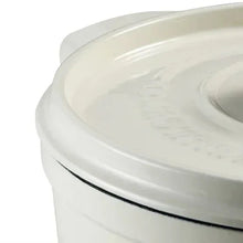 White enameled Dutch oven lid edge with dark trim and knob