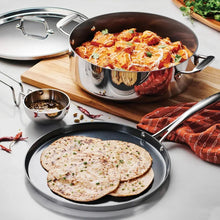 Covered stainless casserole with lid and dosa tawa, plus small ladle on tray
