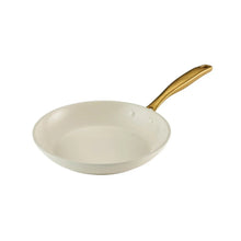 Cream fry pan with gold handle and ceramic interior, shallow cooking surface