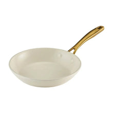 Cream fry pan with gold handle and ceramic interior, wide flat cooking surface