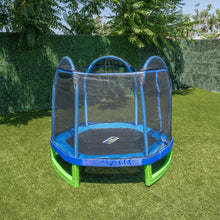 Kids trampoline with blue safety net and green legs on outdoor grass