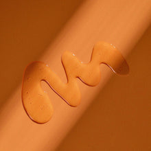 Amber moisturizing shave oil drops on skin, glossy gel texture