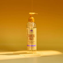 Santal Haze moisturizing shave oil bottle with pump and golden oil sheen