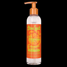 Tree Hut tangerine moisturizing shave oil in a clear pump bottle with orange cap