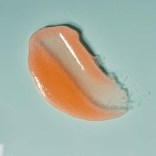 Orange sugar scrub gel scoop with glossy texture