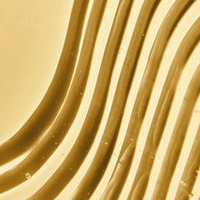 Golden foaming gel wave texture on skin, visible bubbles and sheen