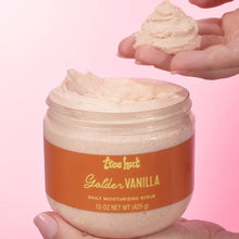 Tree Hut Golden Vanilla daily moisturizing scrub jar with a scoop of scrub