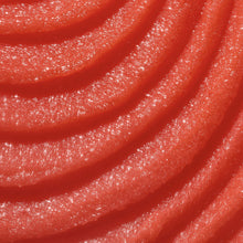Close-up of glossy red sugar scrub with sparkling granules