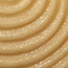 Close-up of golden beige sugar scrub with thick, glittery texture