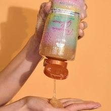 Hands dispensing shimmering gel from a foaming gel body wash bottle