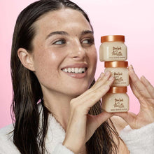 Tree Hut Vanilla shea sugar scrub mini jars held in hands