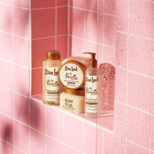 Vanilla bath products on a shower ledge with pump and bottle