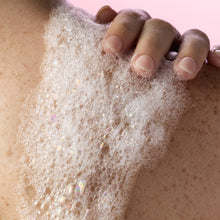 Foaming gel wash lather on skin, suds covering fingertips