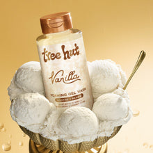 Vanilla foaming gel wash bottle on a bowl with white cotton-like puffs