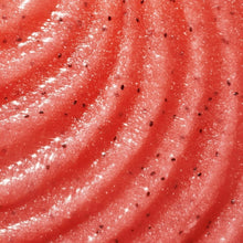 Close-up of pink body scrub texture with sugar granules over skin.