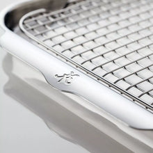 Stainless steel baking tray with embossed grip detail on the rim