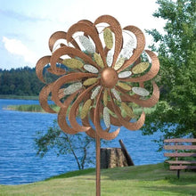 Tri-metallic wind spinner close-up: rust brown flower with multi-tone reflective petal inserts