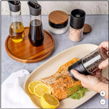 Lazy susan seasoning station with wooden base, glass jars, and black lids