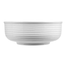 White porcelain serving bowl with horizontal ribbed band across the exterior