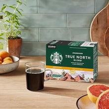 K-Cup pod box on table beside a filled coffee cup, Starbucks True North blend