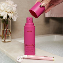 Shave cream bottle being held with cap removed by hand