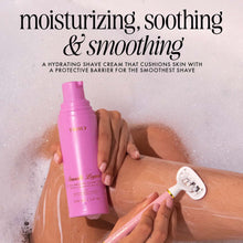 Hydra-Smooth shave cream bottle held in hand during shaving