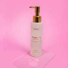 Front-view Truly Vanilla Baby luxury shave oil bottle with gold pump; white bottle