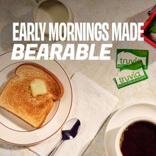 Sweetener packet near breakfast plate with toast, butter, and coffee cup