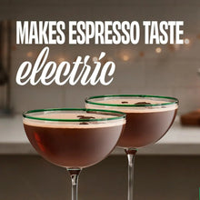 Two espresso drinks in martini glasses with foam tops