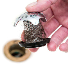 Stainless steel drain strainer with mesh and black base holding dark hair