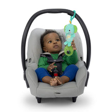 Teal elephant clip-on plush toy hanging from stroller handle bar